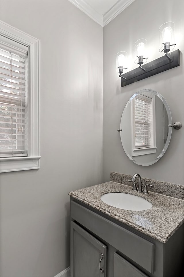 bathroom with ornamental molding, a wealth of natural light, and vanity