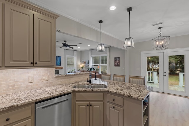 kitchen featuring sink, dishwasher, french doors, ceiling fan with notable chandelier, and decorative backsplash