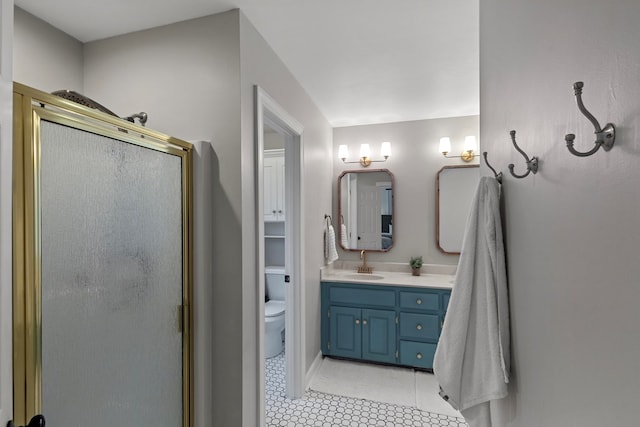 bathroom with a shower with door, tile patterned floors, vanity, and toilet