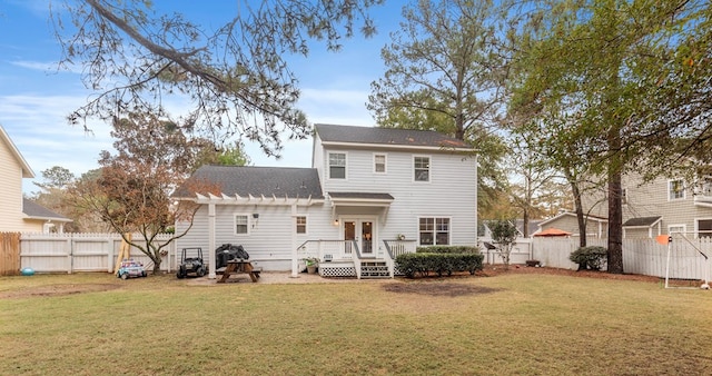 rear view of property with a yard and a wooden deck