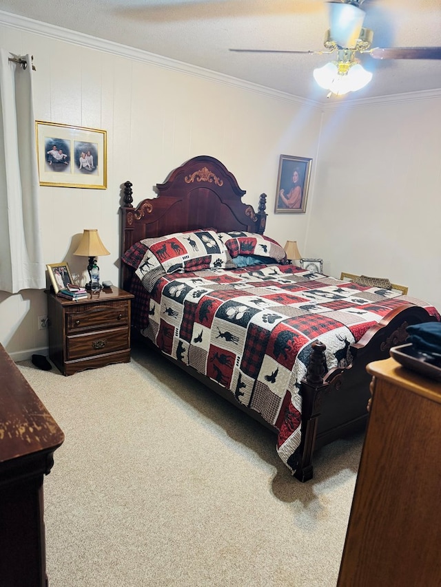 bedroom featuring ceiling fan, ornamental molding, and carpet floors