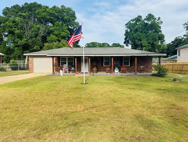 ranch-style home with covered porch, fence, an attached garage, concrete driveway, and a front lawn
