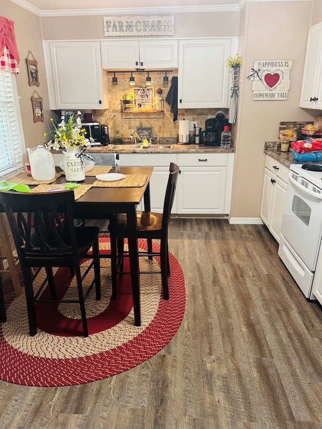 dining area with ornamental molding and dark wood-style floors