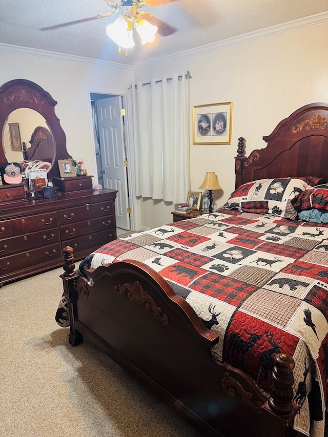 carpeted bedroom with ornamental molding and ceiling fan