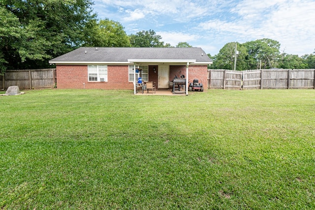 52 Oakwood Dr, Midland City, AL 36350 - rear view of property featuring a patio, a fenced backyard, and brick siding