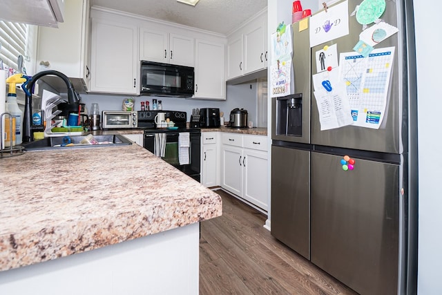 52 Oakwood Dr, Midland City, AL 36350 - kitchen with black appliances, dark wood-style floors, white cabinetry, a textured ceiling, and light countertops