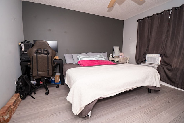 52 Oakwood Dr, Midland City, AL 36350 - bedroom featuring light wood-type flooring, a textured ceiling, and ceiling fan