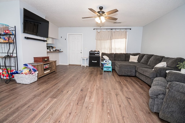 52 Oakwood Dr, Midland City, AL 36350 - living room with wood finished floors, a ceiling fan, and a textured ceiling