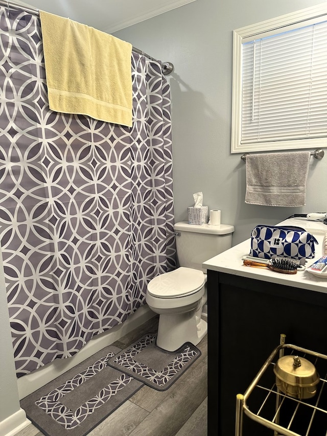 1712 Sowell Rd, Brewton, AL 36426 - bathroom featuring hardwood / wood-style floors, vanity, toilet, and ornamental molding