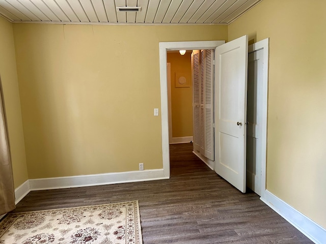 6537 E State Highway 52, Hartford, AL 36344 - spare room featuring wood ceiling, dark wood-style flooring, and baseboards