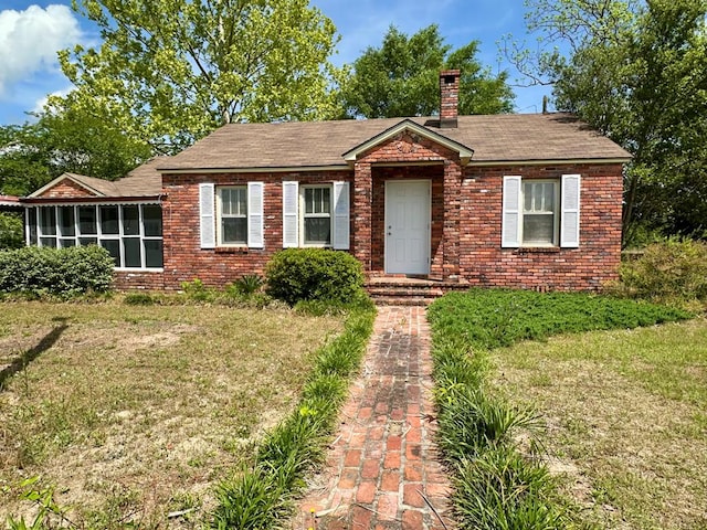 6537 E State Highway 52, Hartford, AL 36344 - single story home featuring a chimney, brick siding, a front yard, and a sunroom