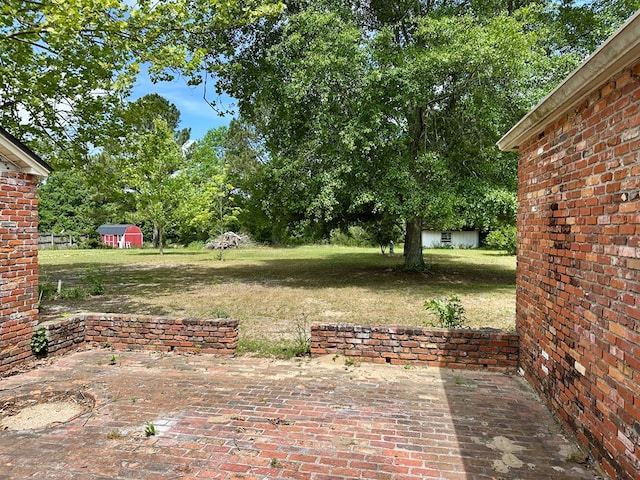 6537 E State Highway 52, Hartford, AL 36344 - view of yard featuring an outdoor structure, a patio, and a shed