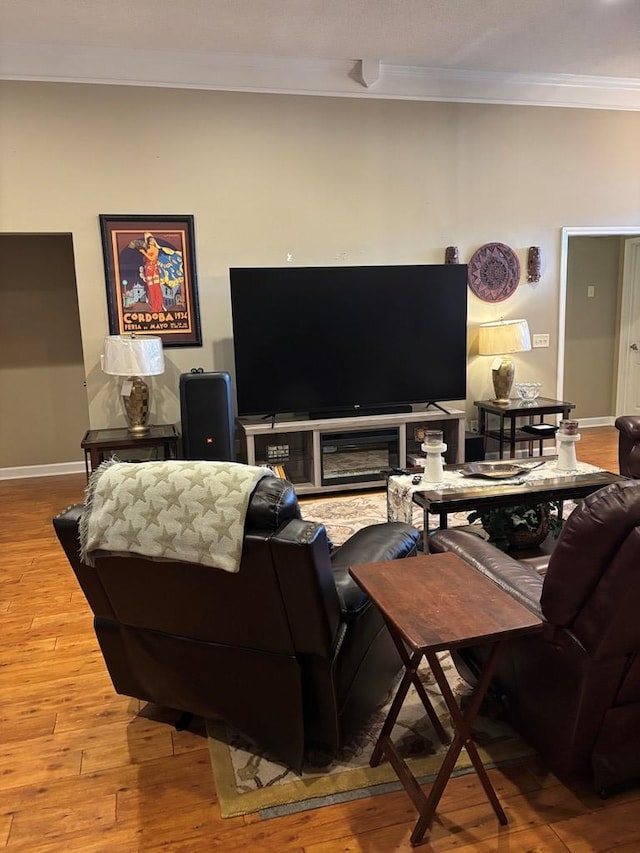 living room featuring crown molding and hardwood / wood-style floors