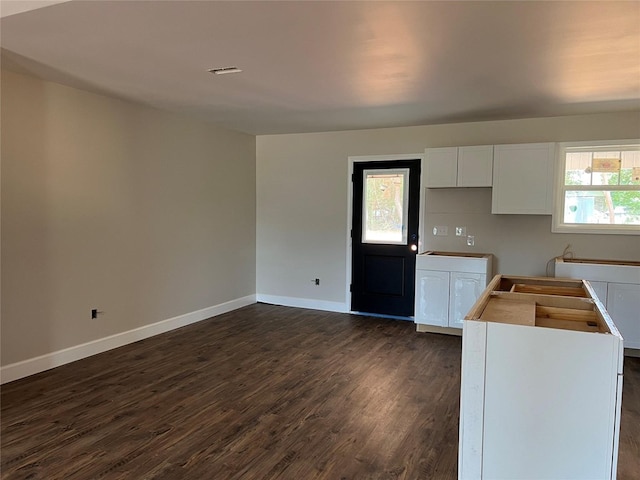 729 Sandstone Dr, Dothan, AL 36303 - kitchen with dark wood-style flooring, baseboards, and white cabinets