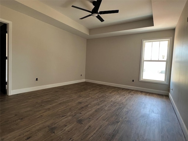 729 Sandstone Dr, Dothan, AL 36303 - unfurnished room with dark wood-type flooring, a tray ceiling, a ceiling fan, and baseboards