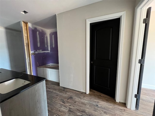 729 Sandstone Dr, Dothan, AL 36303 - kitchen featuring wood finished floors, dark countertops, and a sink