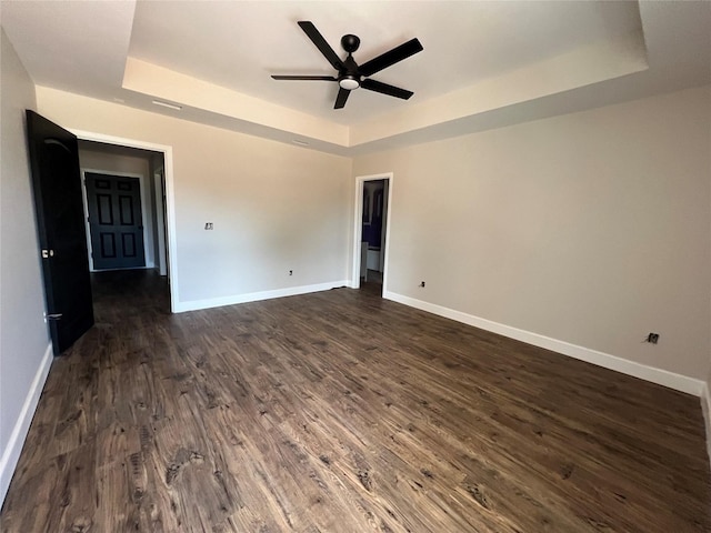 729 Sandstone Dr, Dothan, AL 36303 - unfurnished room with a raised ceiling, ceiling fan, baseboards, and dark wood-type flooring