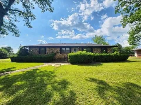 rear view of property with a lawn