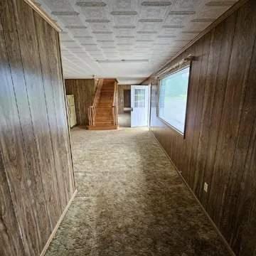 8159 State Highway 10, Shorterville, AL 36373 - hall featuring wooden walls and carpet floors