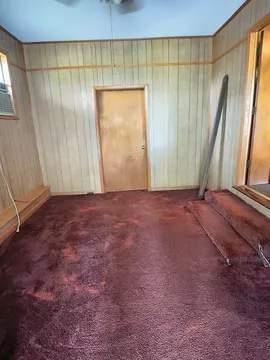 8159 State Highway 10, Shorterville, AL 36373 - carpeted empty room featuring wooden walls