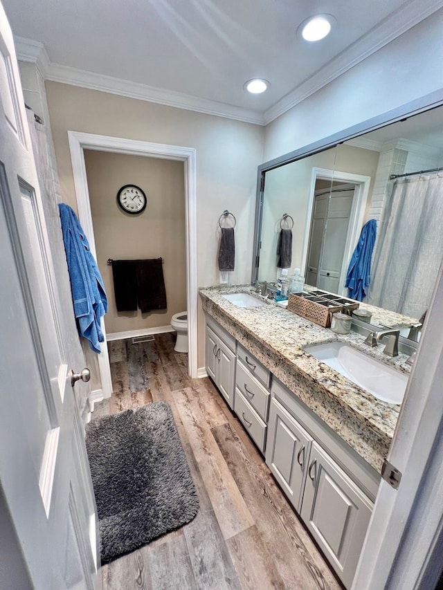 3205 Foxridge Rd, Dothan, AL 36303 - bathroom featuring double vanity, crown molding, wood finished floors, and recessed lighting