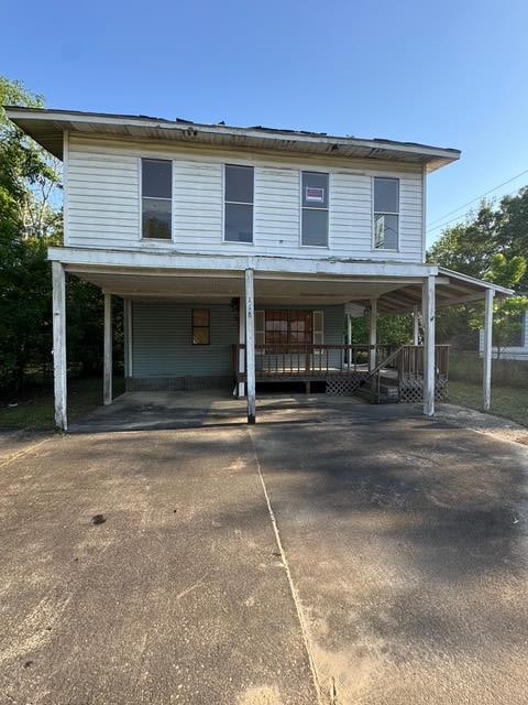 118 E Campbell Ave, Geneva, AL 36340 - view of front of property with covered porch, a carport, and concrete driveway