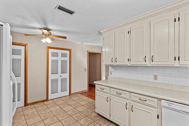 kitchen featuring white cabinetry, ceiling fan, tasteful backsplash, white dishwasher, and light tile patterned floors