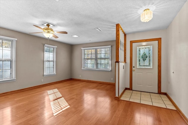 foyer with ceiling fan and light hardwood / wood-style flooring