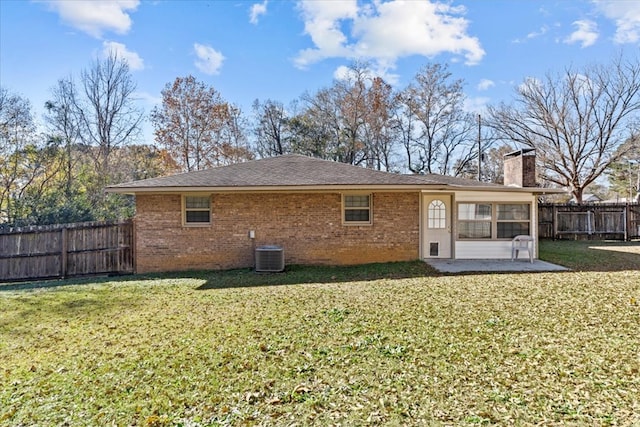 back of property featuring a lawn, cooling unit, and a patio