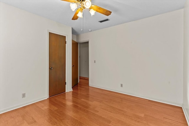 empty room featuring ceiling fan and light hardwood / wood-style floors