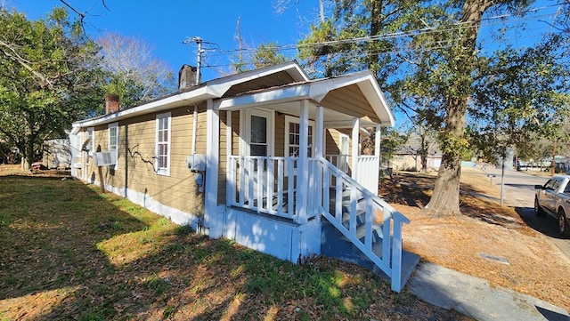 view of side of home with a porch