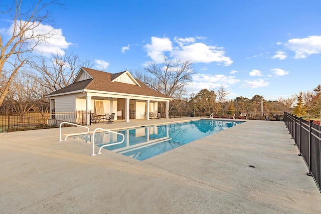 view of swimming pool with a patio area and an outbuilding