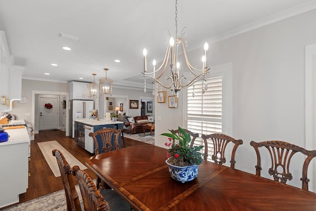 dining space with a chandelier, dark hardwood / wood-style flooring, and crown molding