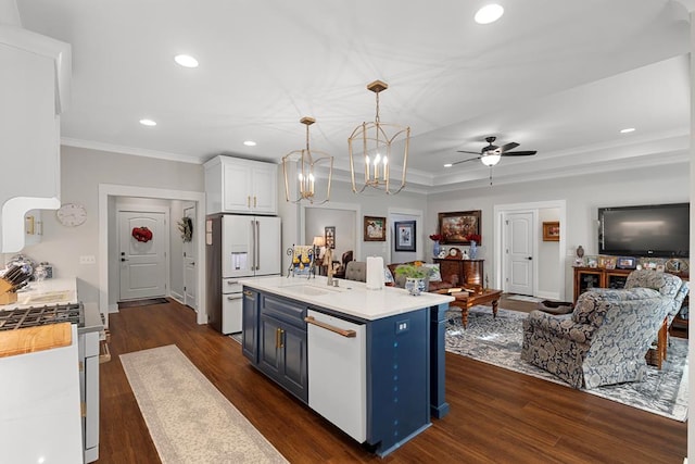 kitchen with decorative light fixtures, an island with sink, white cabinets, blue cabinets, and white appliances