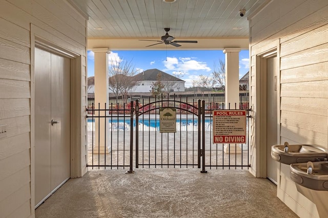 exterior space featuring a community pool and ceiling fan