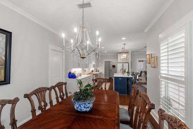 dining area with crown molding and a chandelier