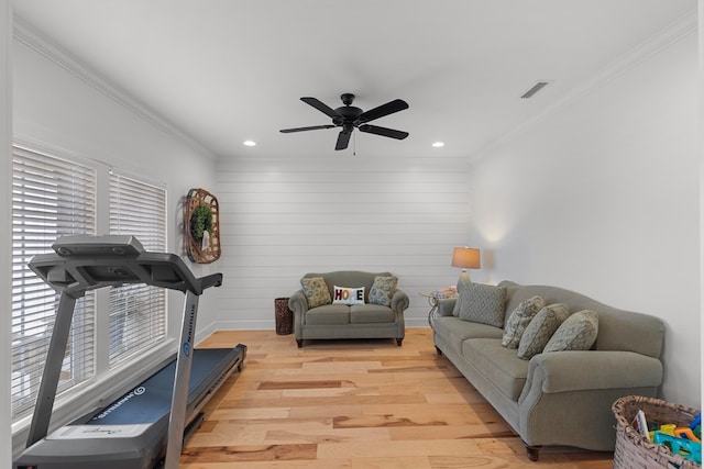 workout room featuring a wealth of natural light, crown molding, ceiling fan, and light hardwood / wood-style floors