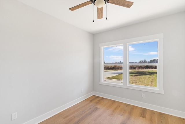 unfurnished room with light wood-style floors, ceiling fan, and baseboards