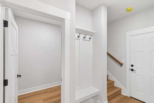 mudroom with light wood-style floors and baseboards