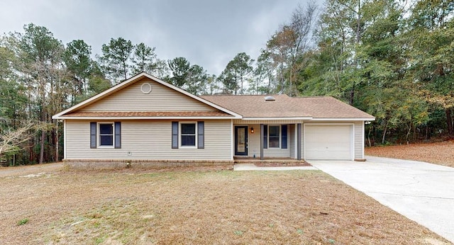 single story home with a garage, covered porch, and a front lawn