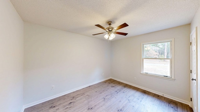 unfurnished room featuring ceiling fan, light hardwood / wood-style flooring, and a textured ceiling