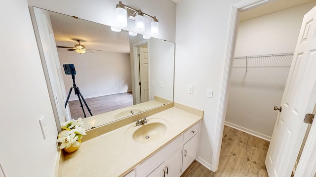 bathroom featuring vanity, hardwood / wood-style floors, a textured ceiling, and ceiling fan