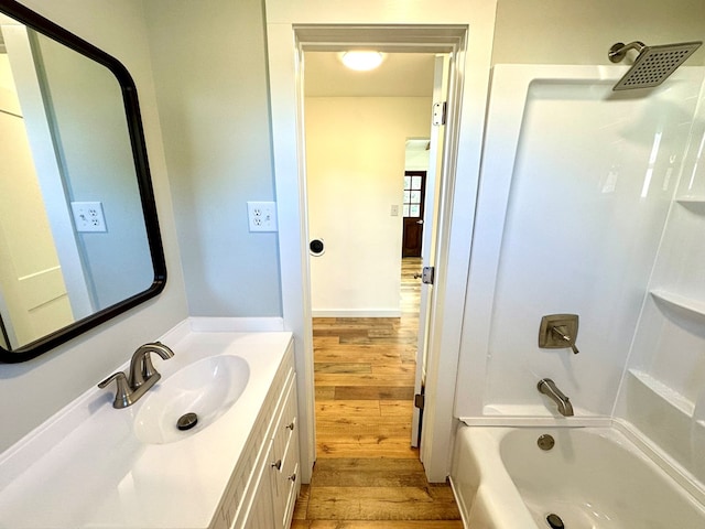 bathroom with shower / tub combination, vanity, and hardwood / wood-style flooring