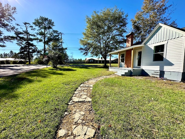 view of yard with covered porch