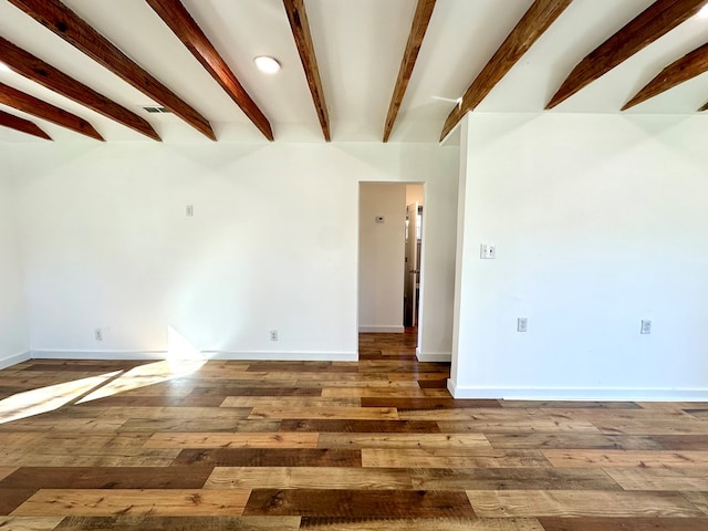 empty room with beam ceiling and hardwood / wood-style floors