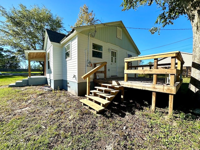 rear view of property featuring a deck