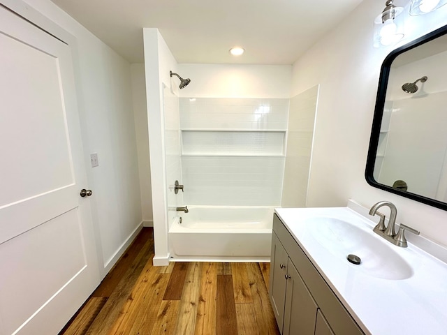 bathroom with vanity, hardwood / wood-style flooring, and shower / bathtub combination