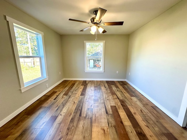 empty room featuring hardwood / wood-style floors, ceiling fan, and a healthy amount of sunlight