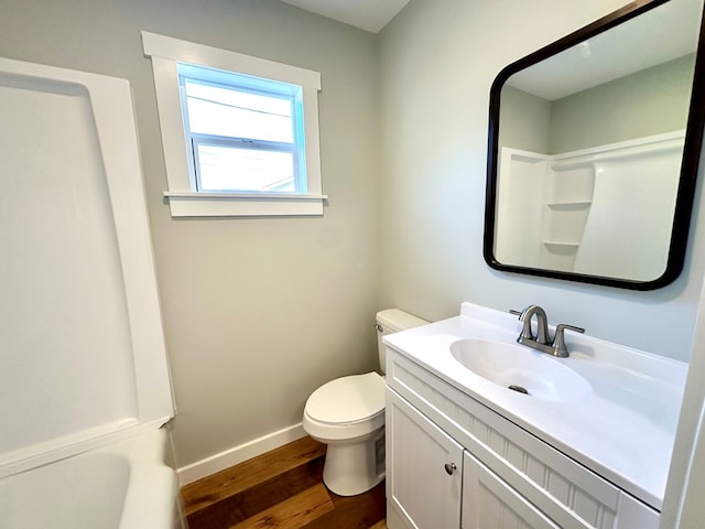 bathroom featuring hardwood / wood-style flooring, vanity, and toilet