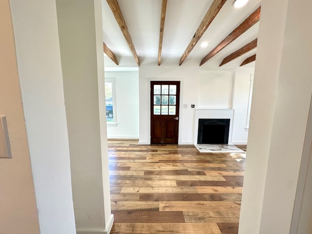 foyer entrance with beam ceiling and hardwood / wood-style flooring